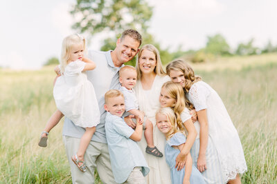 Family of eight in a meadow in Blue Springs, MO