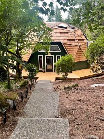 Wood deck installation around home exterior, enhancing outdoor living space
