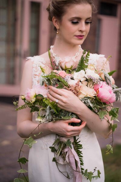 Bride cradling bouquet