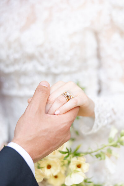 wedding couple holding hands under tented wedding