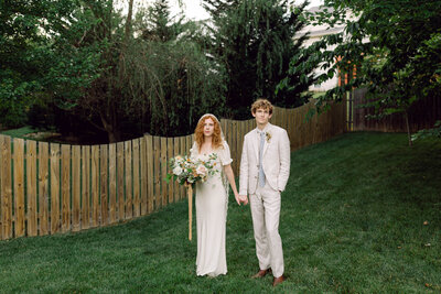 Bride and groom pose looking at the camera for Virginia film wedding photography experience with their photographer. 