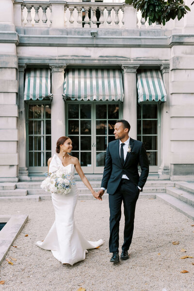 Bride and groom by the reflecting pool at Larz Anderson House in Washington DC, with the bride holding a classic white bouquet. Luxury wedding flowers by Springvale Floral, editorial floral design serving DC, Virginia, and Maryland.
