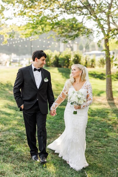 bride and groom holding hands at outdoor wedding