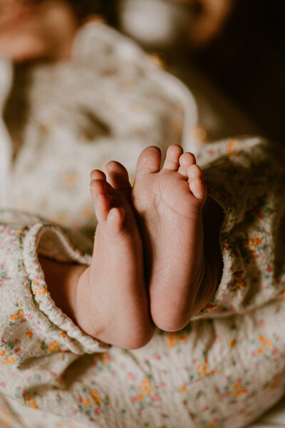 Tiny baby toe details during a relaxed newborn session at home