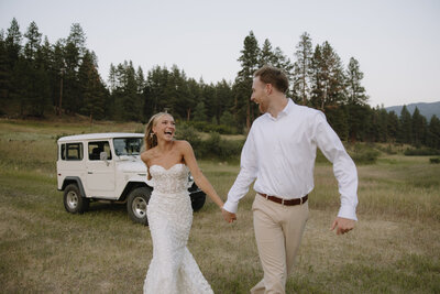 bride and groom running and laughing 