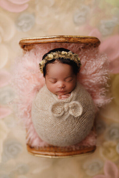 baby girl in a bed prop