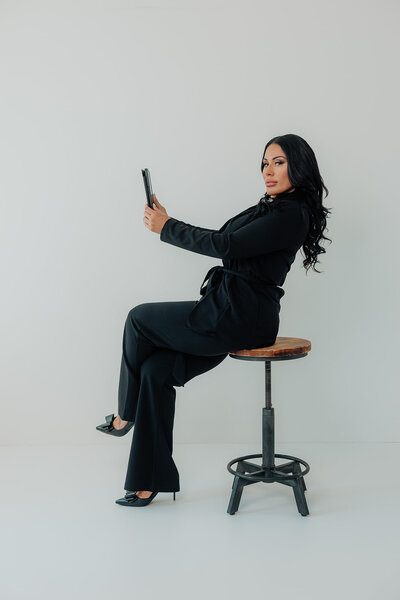 a woman at a photo shoot posing with her ipad