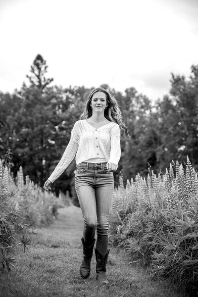 Black & White Photo of Girl Walking through flower field | Senior Session Photography