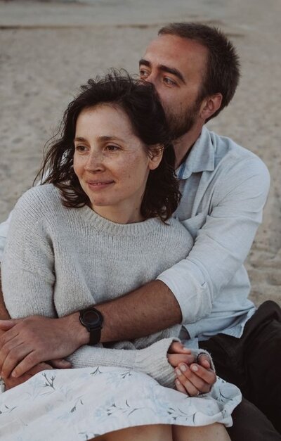 Happy smiling couple on the beach as a symbol of forgiveness in the aftermath of infidelity