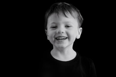 Little boy laughing during school portraits in Wheaton, IL