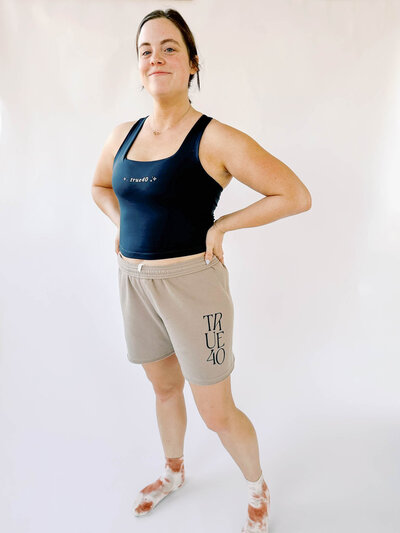 zoomed out view of woman wearing branded sweat shorts