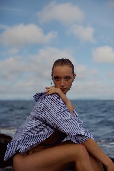 Young woman on a boat with a shirt and wet hair