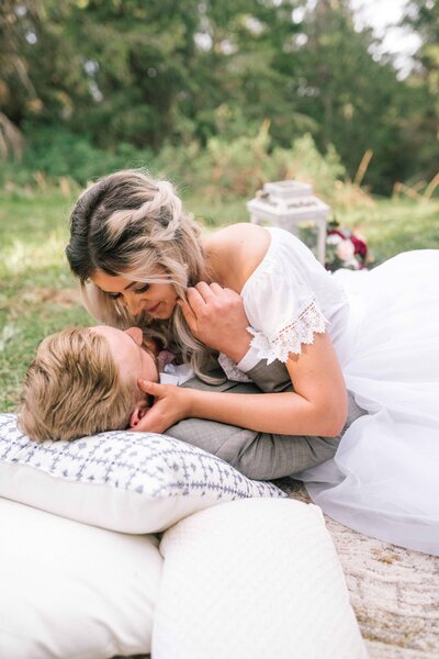 Lake Tahoe wedding photographer captures couple laying on picnic blanket for forest bridals