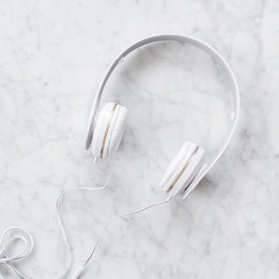 White headphones on marble backdrop