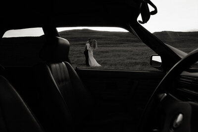 B+W image of couple through car window