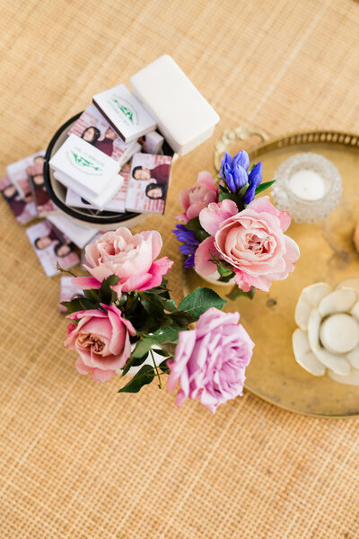 A detail of flowers and prints of the couple's engagement session.
