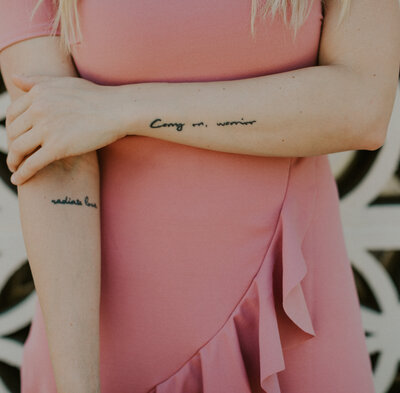 woman with dainty forearm tattoos