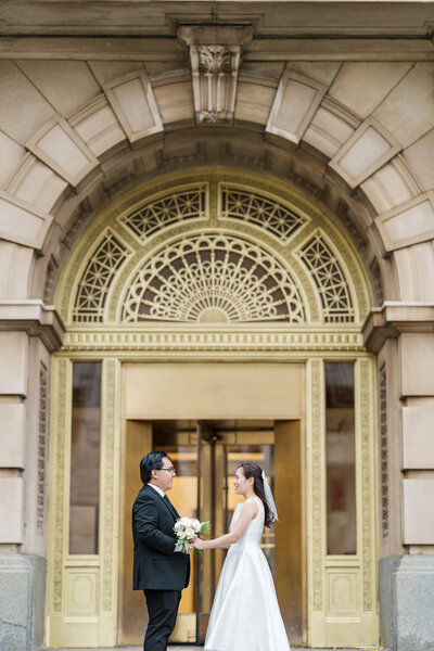 At the downtown Omaha courthouse, a groom and bride prepare for their ceremony. Wedding photo by Claire Katan Creative.