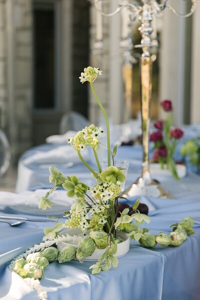 Luxury wedding centerpiece with pastel florals and taper candles on reception table – Colorado wedding floral design at Greystone Castle