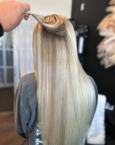 Seamless blonde extensions applied at Lavender & Ink Studios for added length and volume