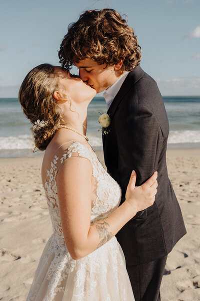 bride and groom kissing florida beach wedding