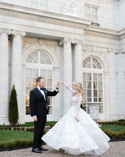 Groom twirling bride at Newport wedding