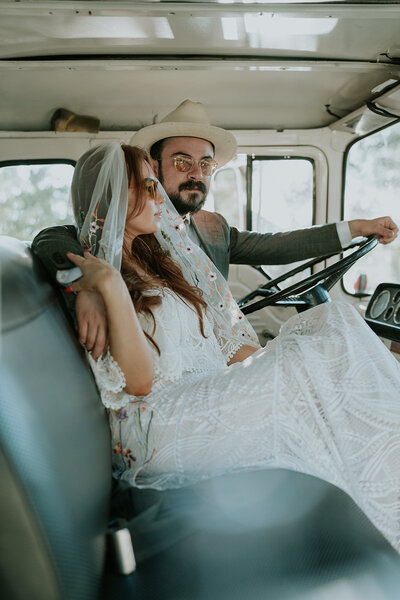 Bride and groom sitting in a classic truck after wedding vows. 