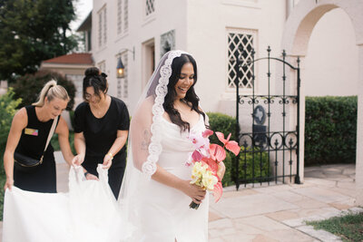 Austin wedding planners Bianca Nichole and Co helping bride down aisle at Laguna Gloria