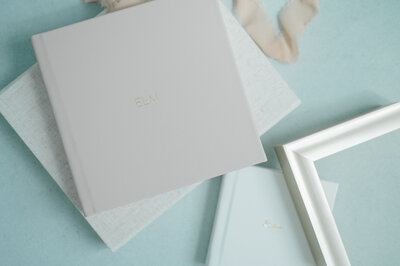 Jessica Jeremiah Photography holding album of maternity portraits