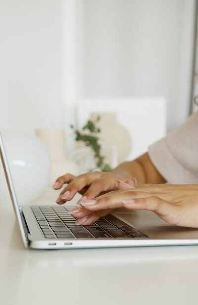 Manicured fingertips on keyboard