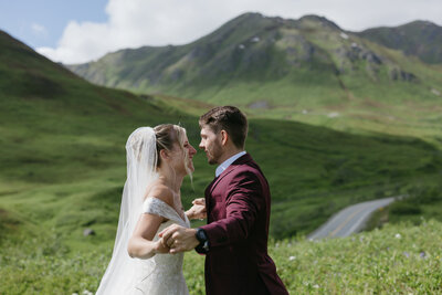 A couple holding hands in the mountains.