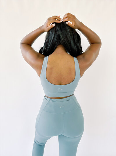 Woman wearing a matching blue top and bottom workout set