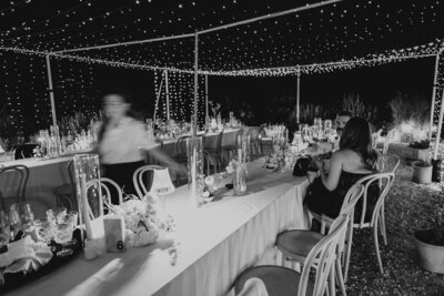 bride and groom laughing on dock on lake