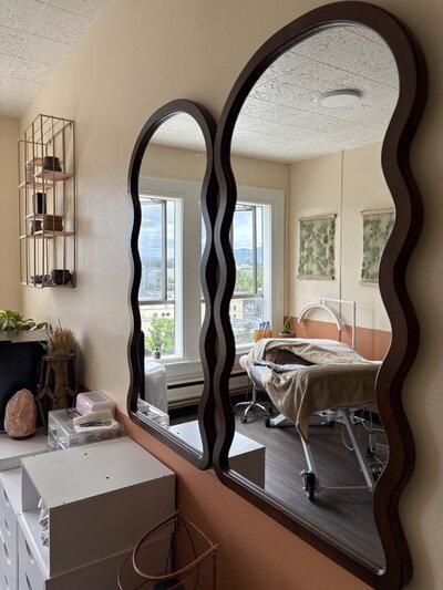 Mirrors on a wall reflect Libby's studio where she provides facials to her clients in Eugene. 