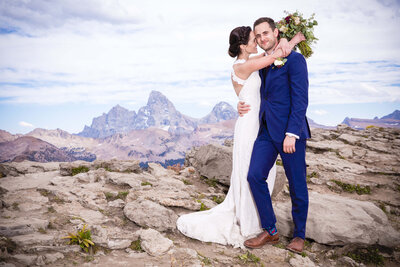 A bride and groom at their Grand Targhee wedding stand with the Grand Teton in the background.