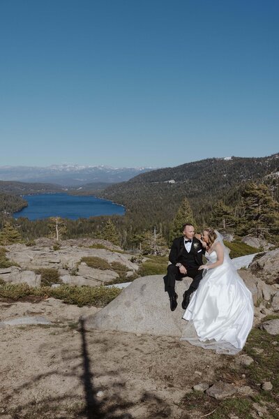 bride and groom holding each other in lake tahoe