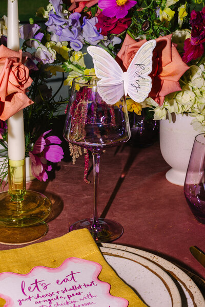 Close up flash photo of receiption table setting with purple and yellow color theme