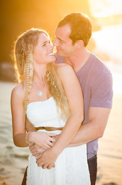 Couple embracing during a beautiful sunset at the beach in La Jolla taken by ABM Photography