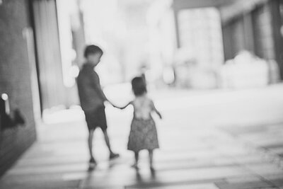 black and white image children holding hands