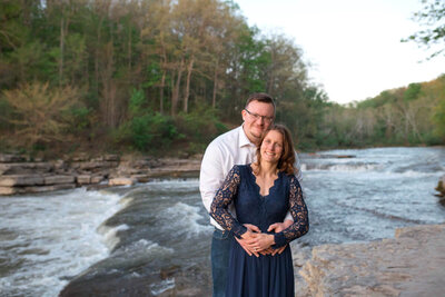 Engaged couple in front of a waterfall