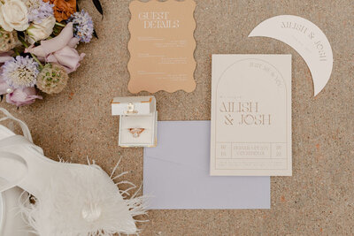 flat lay of invite suite, rings, florals, and shoes on elopement day