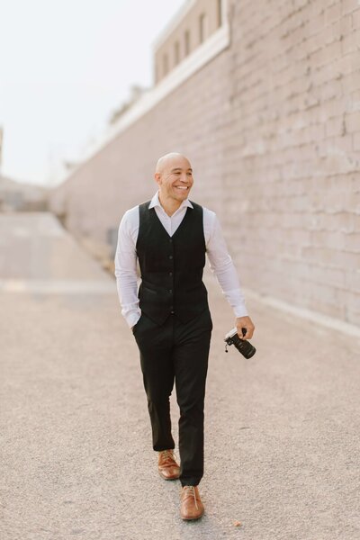 Minneapolis Wedding Videographer Ariel walking with Camera