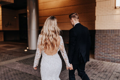 Nashville wedding photographer captures bride and groom holding hands outdoors