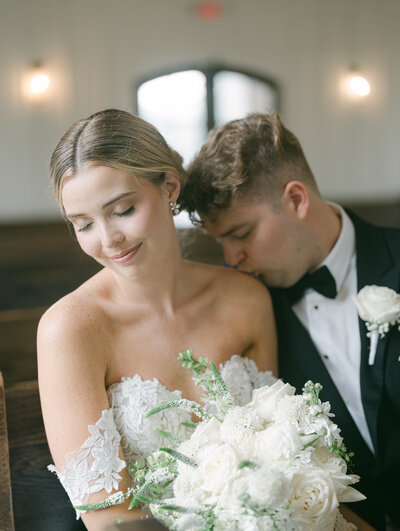 Groom kissing bride’s shoulder during an intimate moment at their Nashville wedding, captured by Diana Marie Photography.