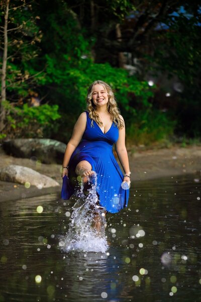 Girl in blue dress kicking water | Senior Session