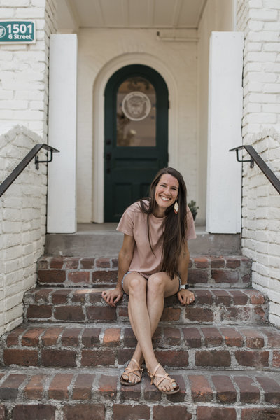 woman sitting on steps smiling