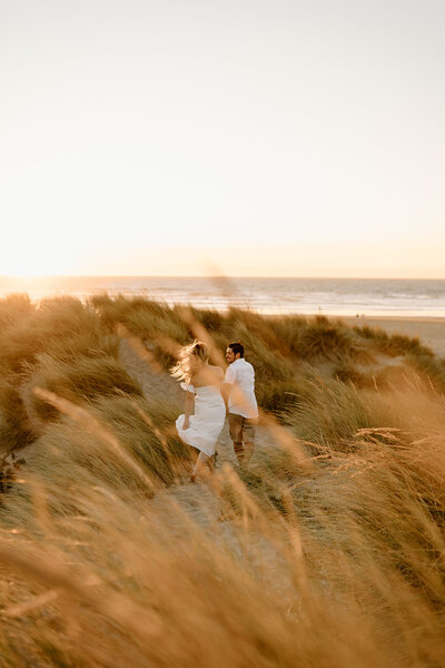 couple hugging in sand dunes