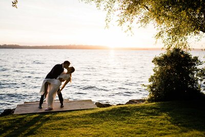 Husband kissing new wife at Seattle waterfront with love and romance all around captured by Washington wedding photographers