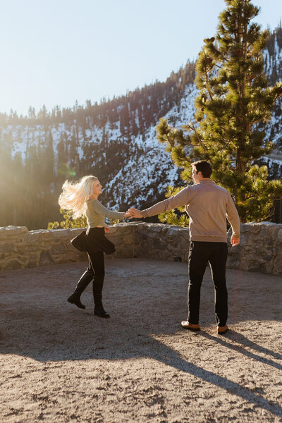 Romantic twirl after surprise proposal at Logan Shoals in Lake Tahoe