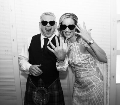 Couple in black and white wedding picture at house of an art lover showing wedding rings